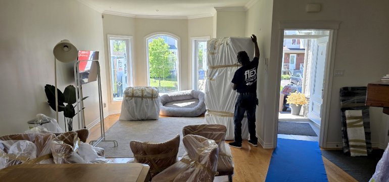 Flex Moving Montreal professional mover protecting a sofa and furniture during relocation
